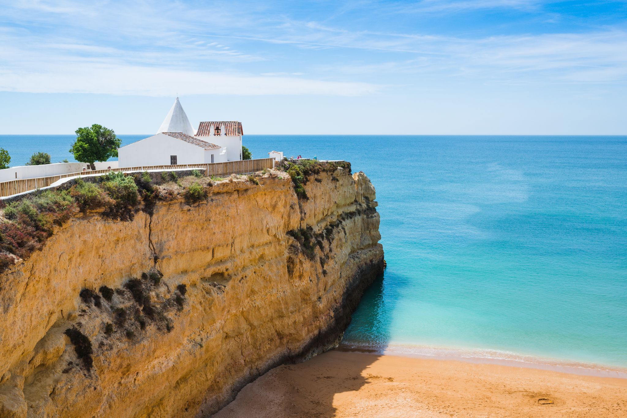 Photo of the Chapel of Nossa Senhora da Rocha on top of the spectacular cliffs on Nova Beach, Porches, Region Algarve, Portugal.