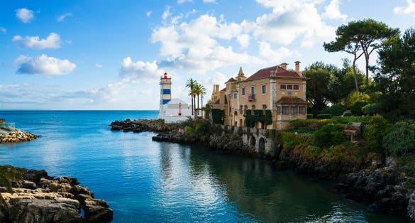 Photo of beautiful view of Cascais ,coastal resort and fishing town, with Santa Maria House and Lighthouse , Portugal.