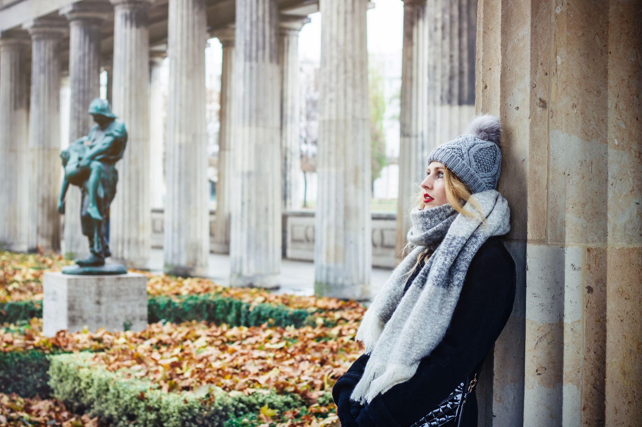 Young beautiful traveling woman in park of the Old National Gallery - Alte Nationalgalerie, in Berlin, Germany.