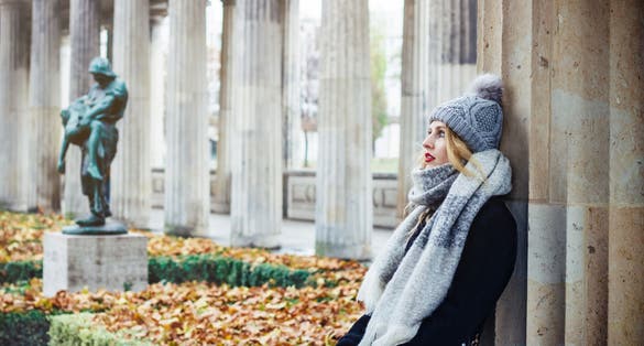 Young beautiful traveling woman in park of the Old National Gallery - Alte Nationalgalerie, in Berlin, Germany.