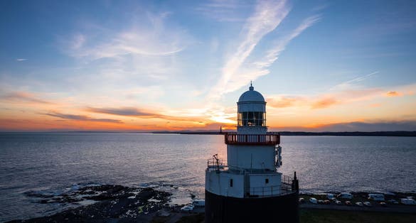 Photo of aerial view of Hook Lighthouse is a building on Hook Head at the tip of the Hook Peninsula in County Wexford, Ireland.