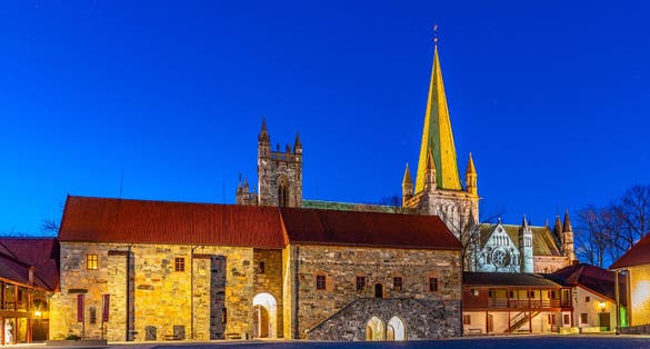 Sunset view of Nidaros cathedral from courtyard of archbishop's palace in Trondheim, Norway