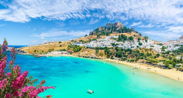 Photo of landscape with beach and castle at Lindos village of Rhodes, Greece.