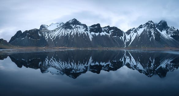 photo of view of Panorama of mirroring Vestrahorn at Stokksnes Iceland near Höfn, Iceland,