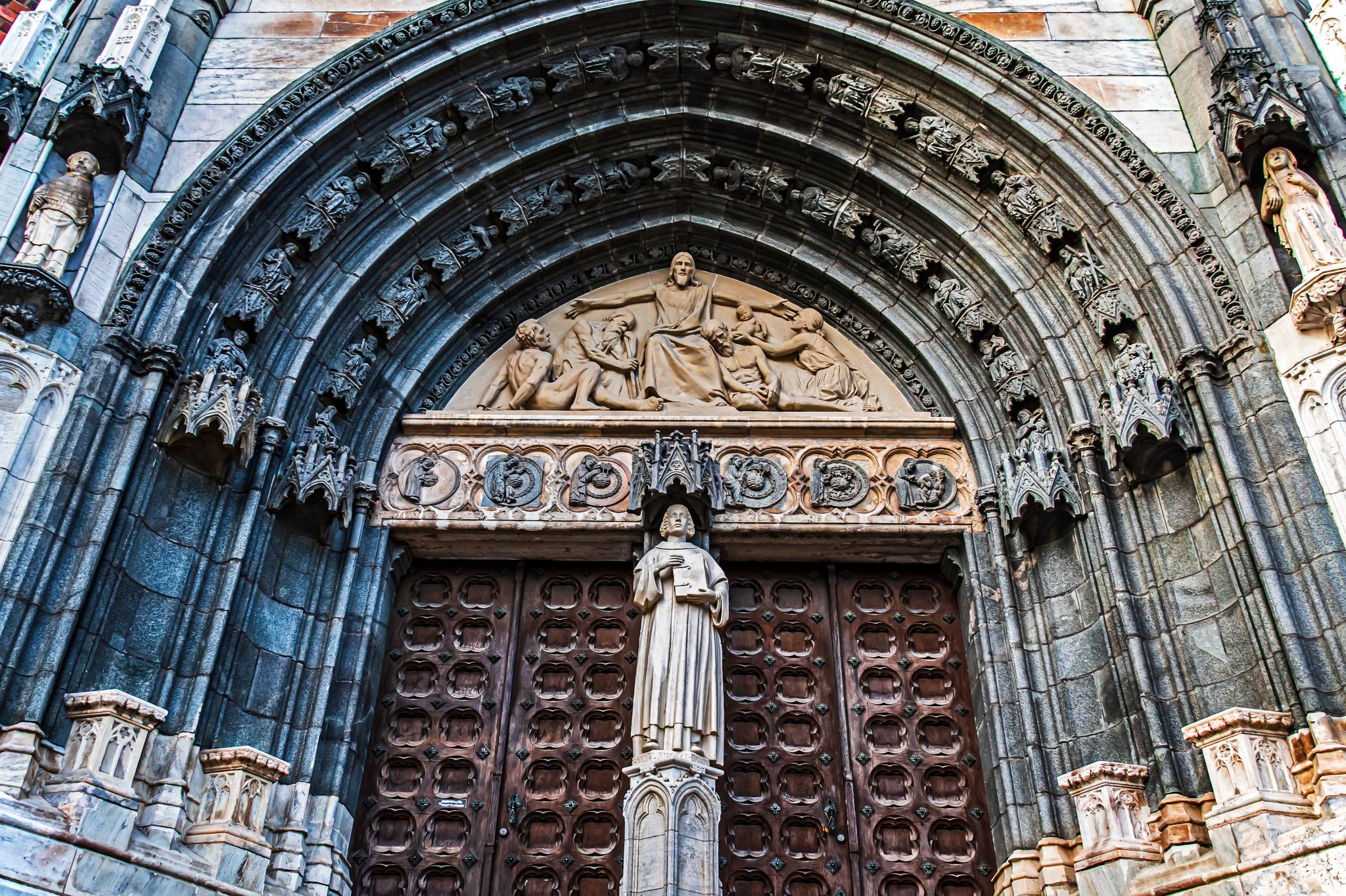 The big main gate to Uppsala Cathedral in Sweden with beautiful decoration around the gate.