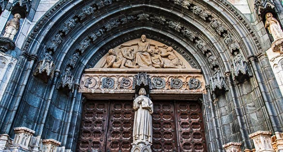 The big main gate to Uppsala Cathedral in Sweden with beautiful decoration around the gate.