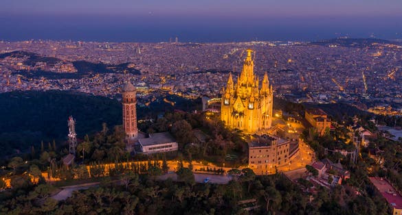 Photo of Aerial view of Barcelona skyline with Sagrat Cor temple at night, Catalonia, Spain .