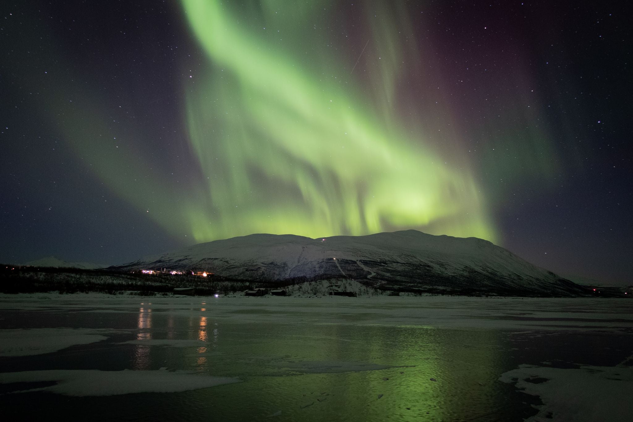 photo of northern lights above Abisko National Park in Sweden.