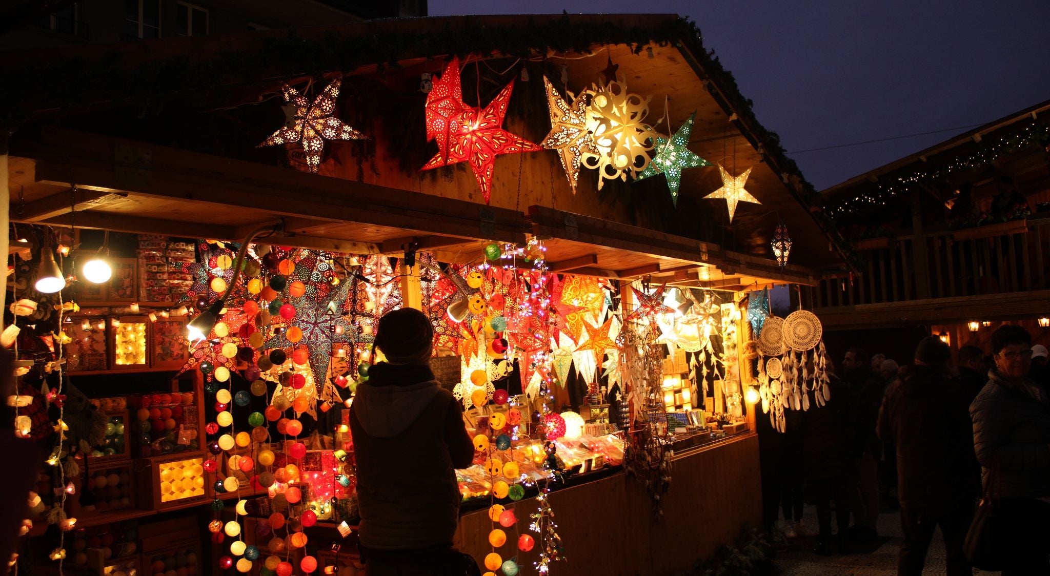 Colorful lanterns and handcrafted decorations at a Christmas market stall in Switzerland..jpg