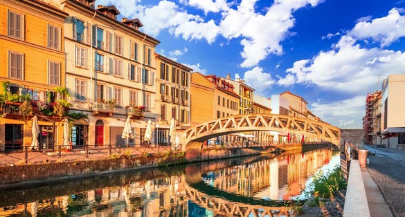 Photo of Milan, Italy. Bridge across the Naviglio Grande canal at the sunrise Milano, Lombardy.
