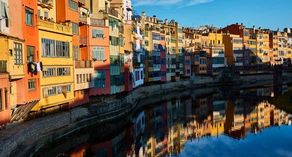 photo of the colored houses on the banks of the River Ter, called Casas del Onyar, in Girona. Catalonia. Spain.