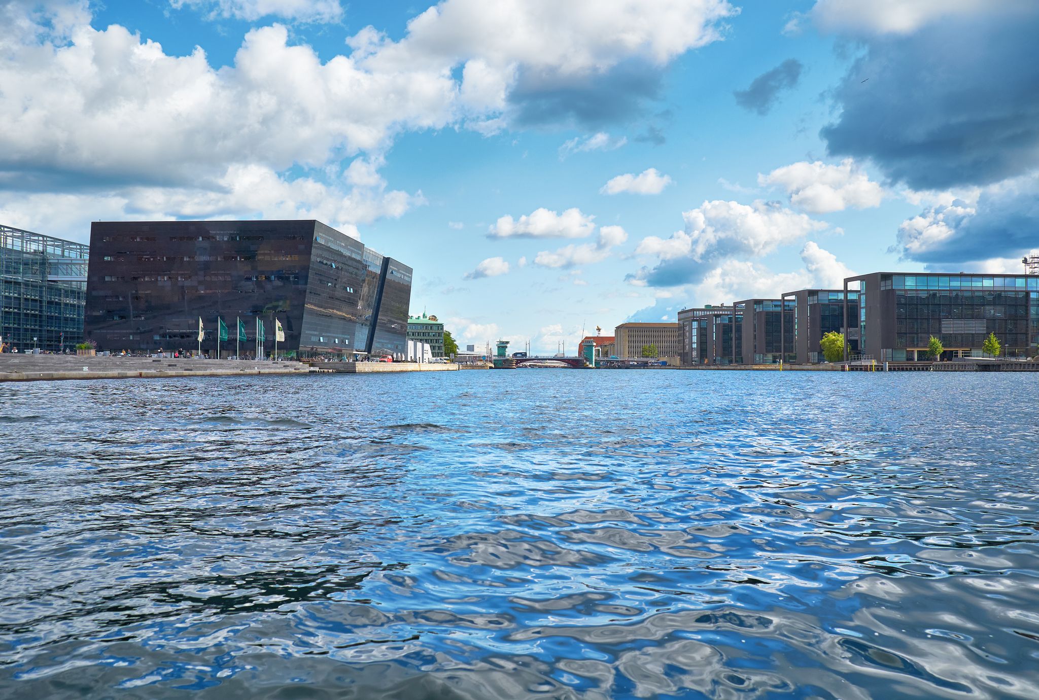 Photo of the view along the main harbour on new building of the Royal Library  and the modern houses in Copenhagen, Denmark.