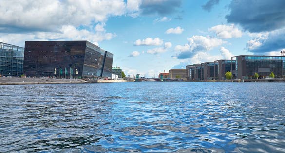 Photo of the view along the main harbour on new building of the Royal Library  and the modern houses in Copenhagen, Denmark.