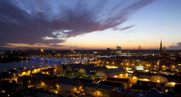 photo of city at night with church towers and bridges. Riga - the capital city of Latvia.