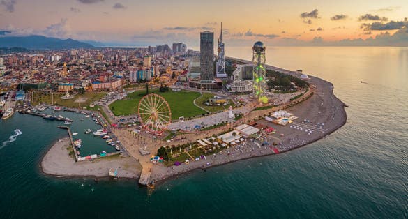 Photo of panoramic aerial view of Batumi, Georgia. The Ferris Wheel and the Alphabet Tower are in the foreground.