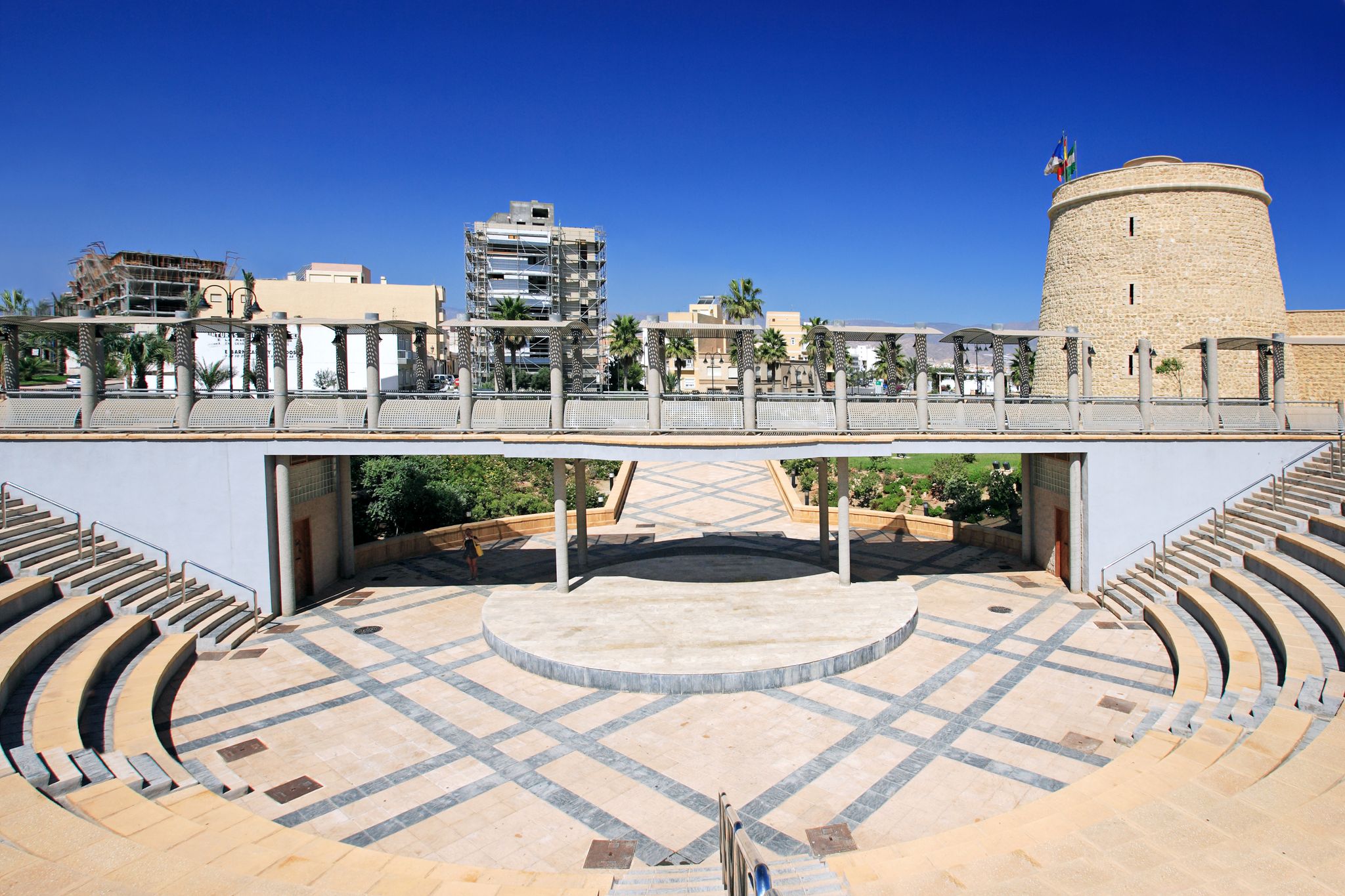 photo of Castillo de Santa Ana it's an ancient castle and Symmetrical and abstract view of Amphitheatre in Roquetas de Mar, Spain.