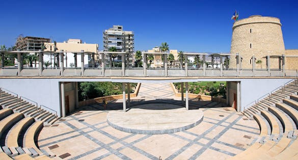 photo of Castillo de Santa Ana it's an ancient castle and Symmetrical and abstract view of Amphitheatre in Roquetas de Mar, Spain.