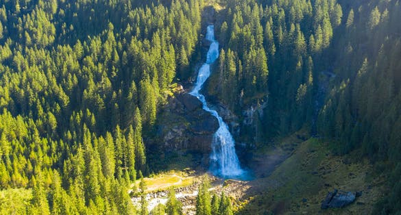 Photo of aerial panoramic view of Krimmler Waterfalls (Krimmler Wasserfalle) and the surroundings forest in Krimml, Austria.