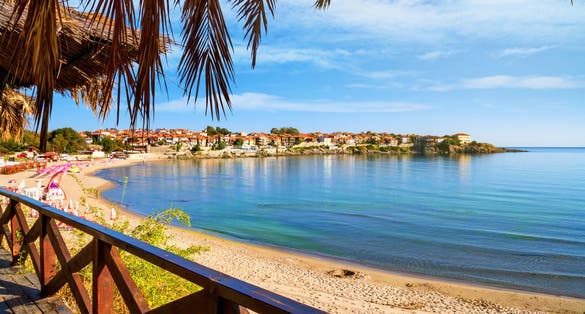 Photo of view from the cafe to the sandy beach with umbrellas and sun loungers in the town of Sozopol on the Black Sea coast in Bulgariaview from the cafe to the sandy beach with umbrellas and sun loungers in the town of Sozopol on the Black Sea coast in Bulgaria.