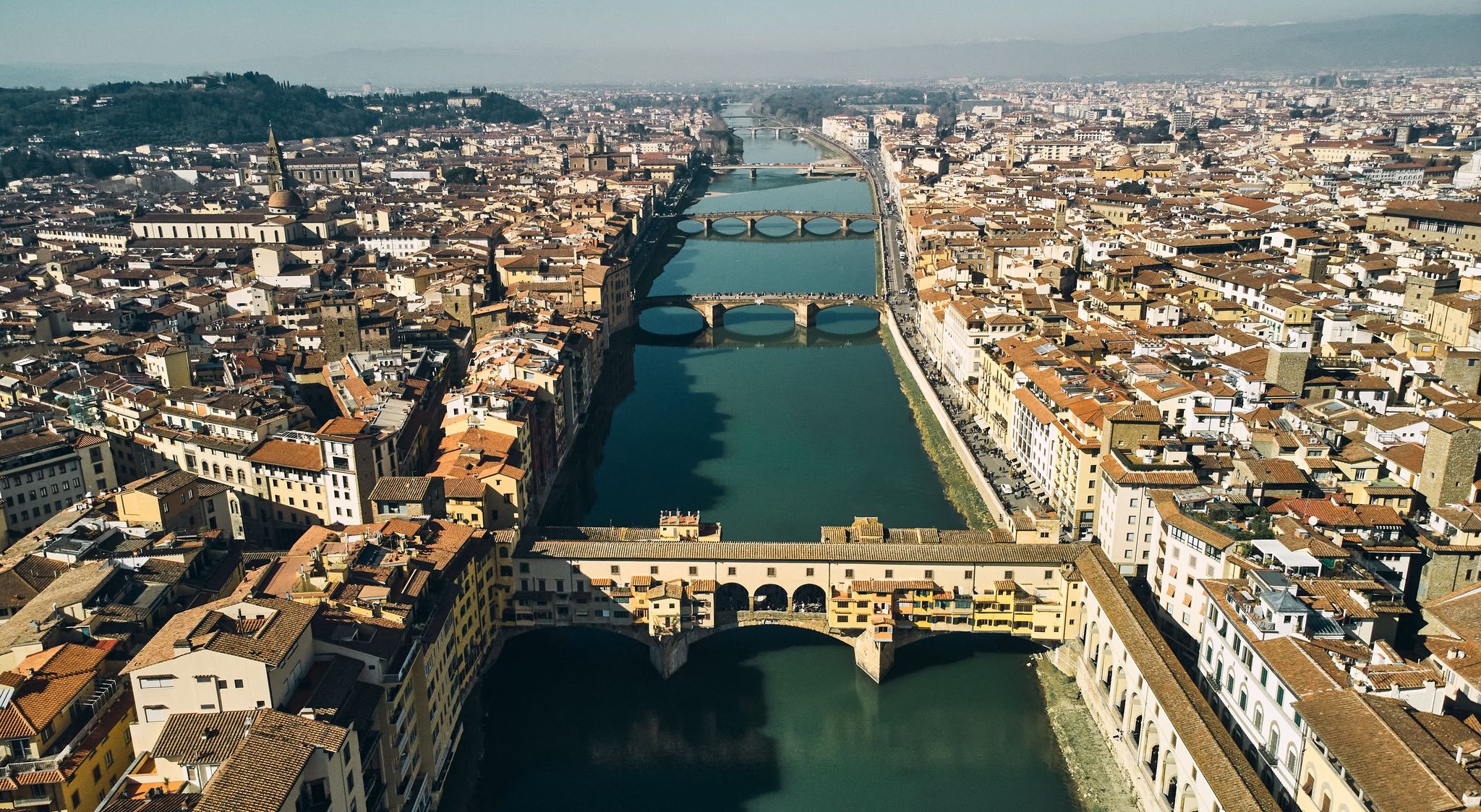 photo of aerial view of ponte vecchio bridge and arno river in Florence.