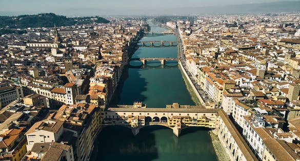 photo of aerial view of ponte vecchio bridge and arno river in Florence.