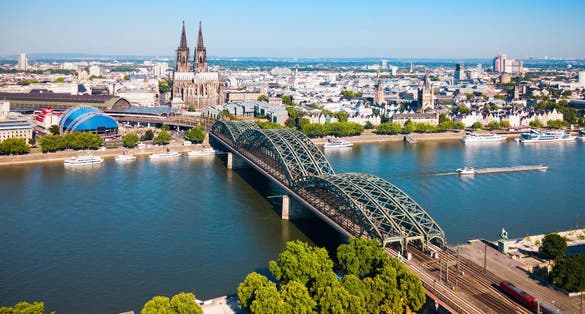 photo of view of Cologne Cathedral and Hohenzollern Bridge through Rhine river aerial panoramic view in Cologne, Germany
