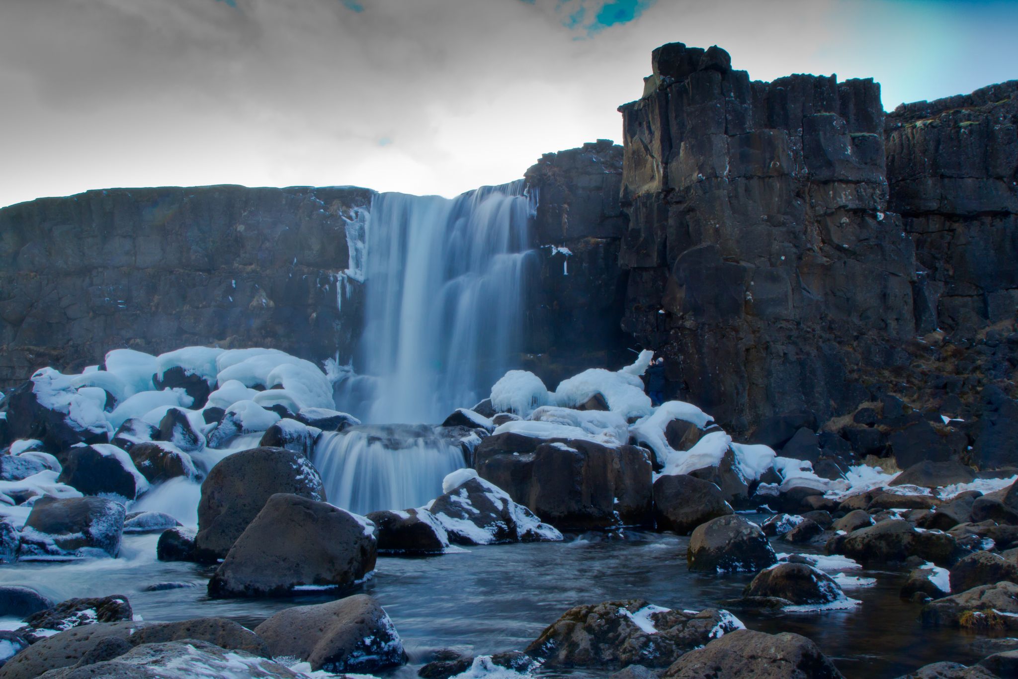 photo of Öxarárfoss is a waterfall in Þingvellir, Iceland. It flows from the river Öxará over the Almannagjá .The pool at the base of the waterfall is filled with rocks and is often extremely icy.