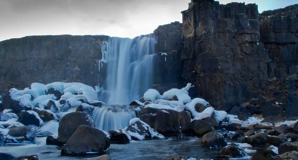 photo of Öxarárfoss is a waterfall in Þingvellir, Iceland. It flows from the river Öxará over the Almannagjá .The pool at the base of the waterfall is filled with rocks and is often extremely icy.