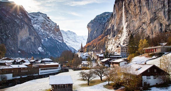 photo of amazing touristic alpine village in winter with famous church and Staubbach waterfall Lauterbrunnen Switzerland Europe.
