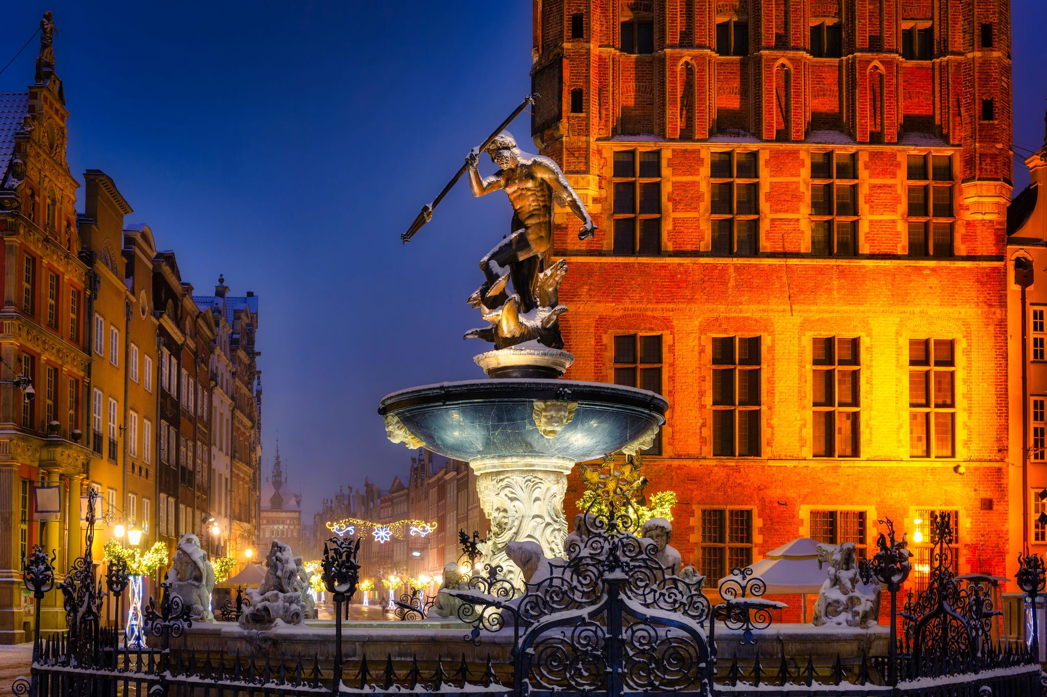 Photo of the famous Neptune's fountain at night in Gdansk, Poland.