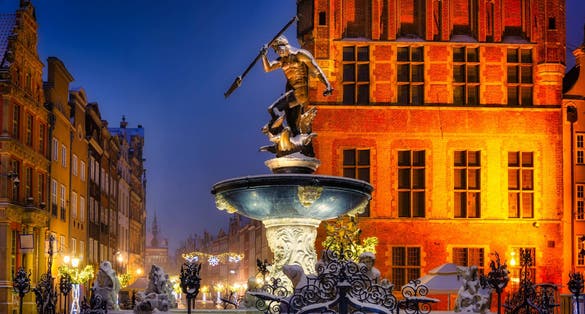 Photo of the famous Neptune's fountain at night in Gdansk, Poland.