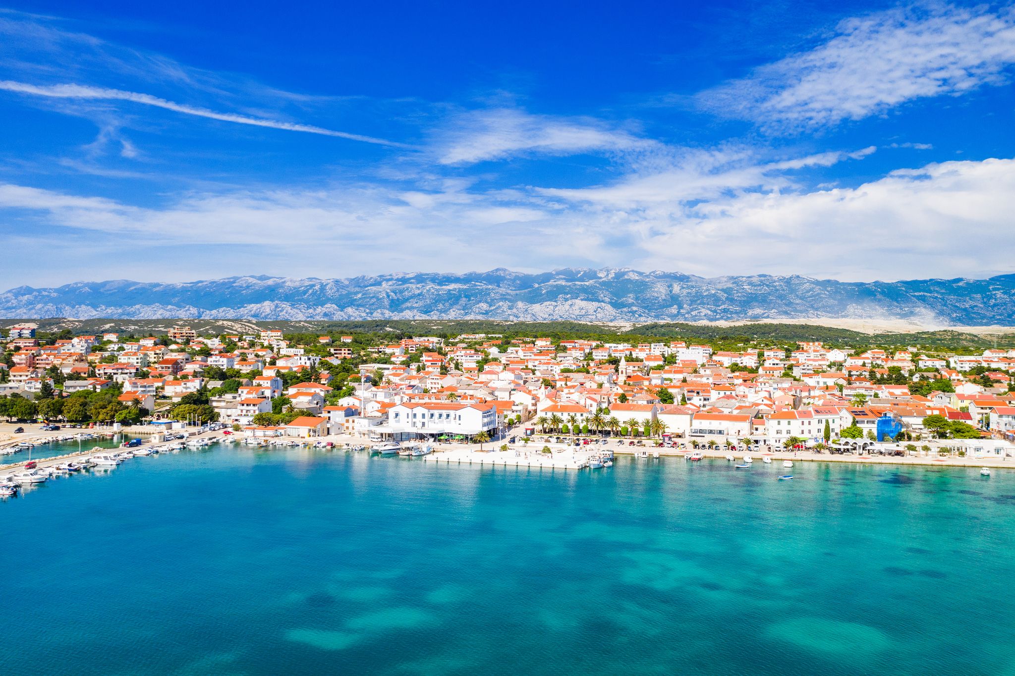 Croatia, beautiful Adriatic coastline, town of Novalja and marina on the island of Pag, aerial view from drone
