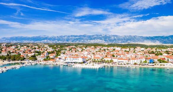 Croatia, beautiful Adriatic coastline, town of Novalja and marina on the island of Pag, aerial view from drone