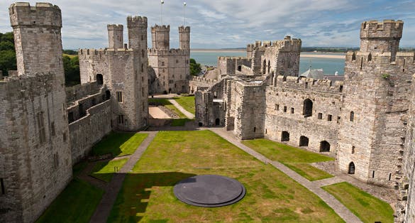Photo of Caernarfon Castle, a medieval fortress in Caernarfon, Gwynedd, north-west Wales.