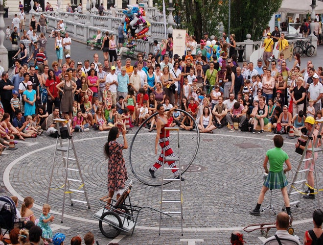 Street performers entertaining a large crowd in Ljubljana’s city center during a summer festival..jpg