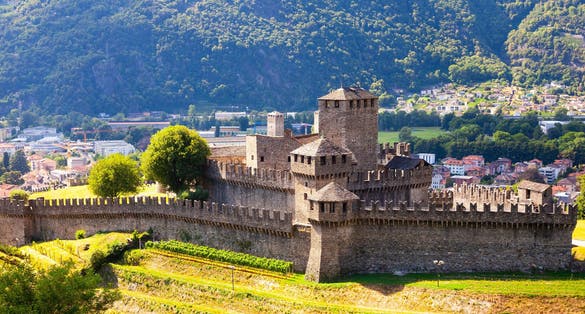 Photo of summer view of medieval fortified Montebello Castle protecting old city of Bellinzona on foothills of Swiss Alps, Switzerland. 