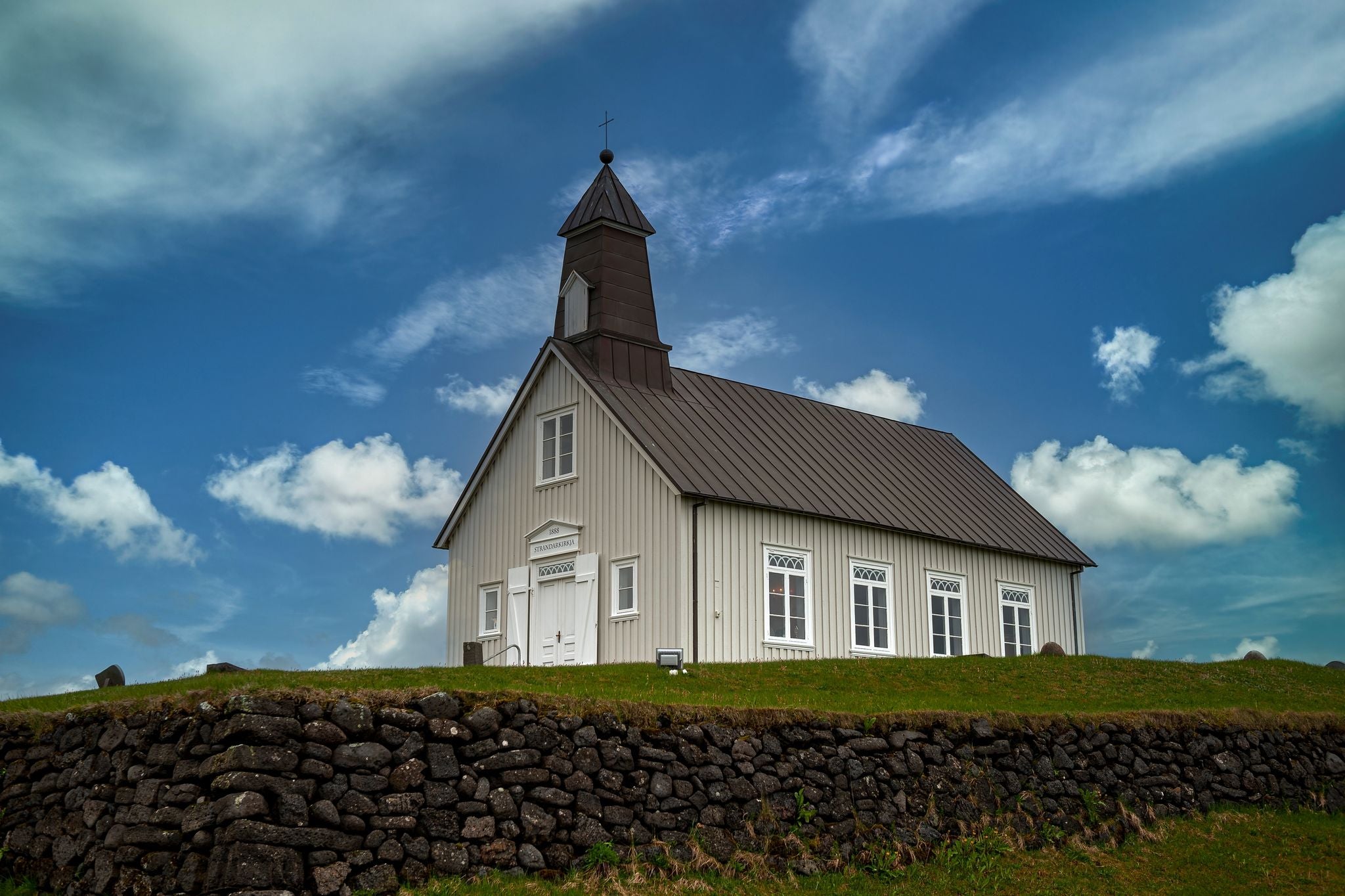 photo of view of The picturesque Strandarkirkja church in Selvogur, on the southern coast of Iceland.