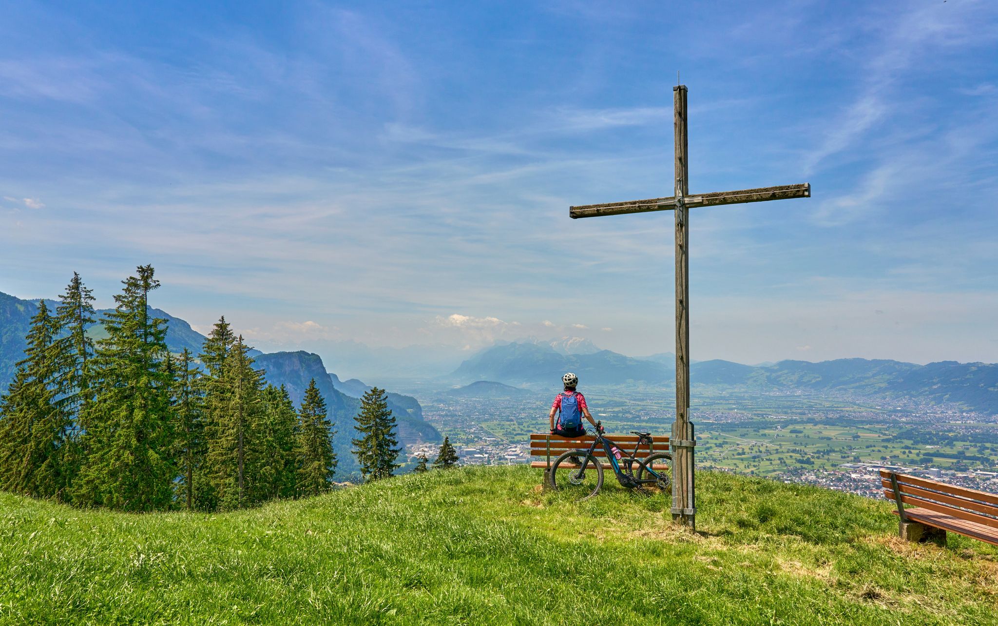 nice senior woman riding her electric mountain bike in the Bregenzer Wald mountain range above Bregenz and Lake of Constance in Vorarlberg, Austria