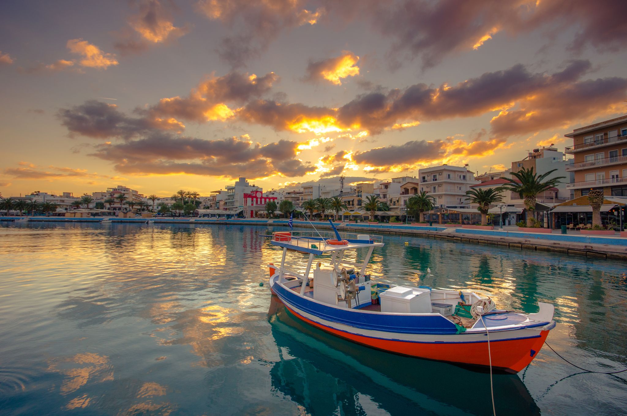 photo of view of The pictursque port of Sitia, Crete at sunset. Sitia is a traditional town at the east Crete near the beach of palm trees Vai.