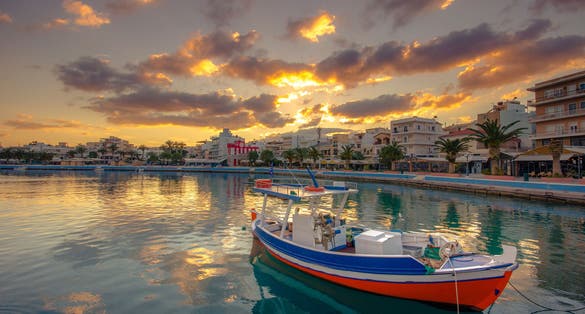 photo of view of The pictursque port of Sitia, Crete at sunset. Sitia is a traditional town at the east Crete near the beach of palm trees Vai.