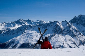 photo of view of Skiing in Savognin. A skier lying on the slope. Swiss Alps.