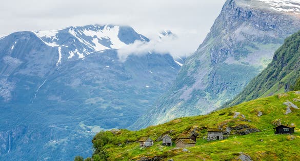 Norwegian mountain village with traditional turf roof houses, Geiranger, Sunnmore region, More og Romsdal county, Norway