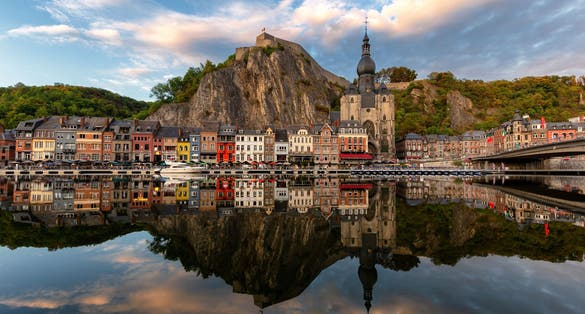 photo of view of Classic view of the historic town of Dinant with scenic River Meuse in beautiful golden evening light at sunset, province of Namur, Wallonia, Belgium