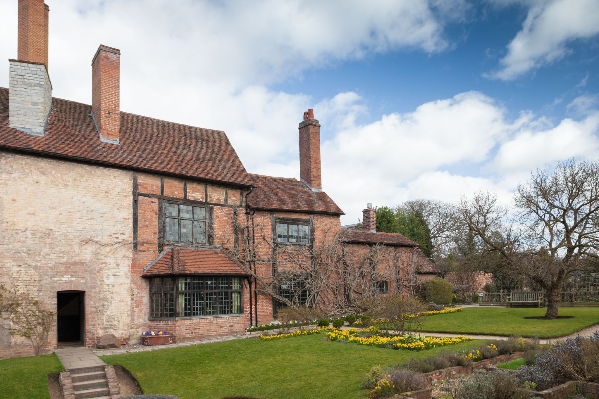 Photo of rear view of the house and gardens at William Shakespeare's House, Stratford upon Avon, England.