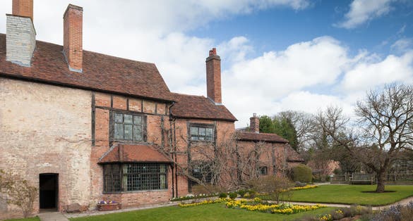 Photo of rear view of the house and gardens at William Shakespeare's House, Stratford upon Avon, England.