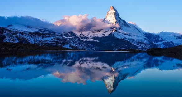 photo of Matterhorn in early morning with reflection in Stellisee in winter, Zermatt, Switzerland.