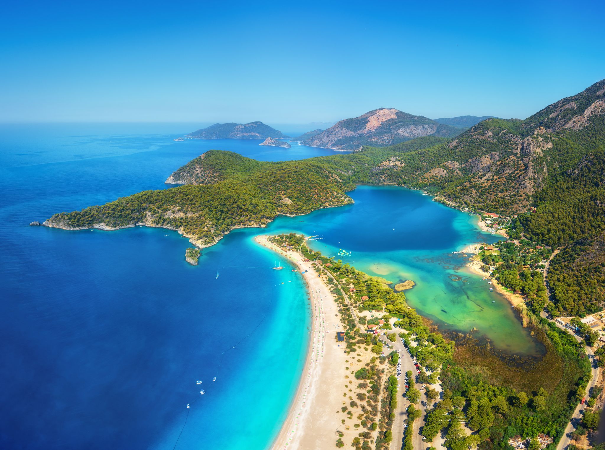 photo of amazing aerial view of Ölüdeniz-Kıdrak Nature Park, Turkey. Summer landscape with mountains, green forest, azure water, sandy beach and blue sky in bright sunny day.