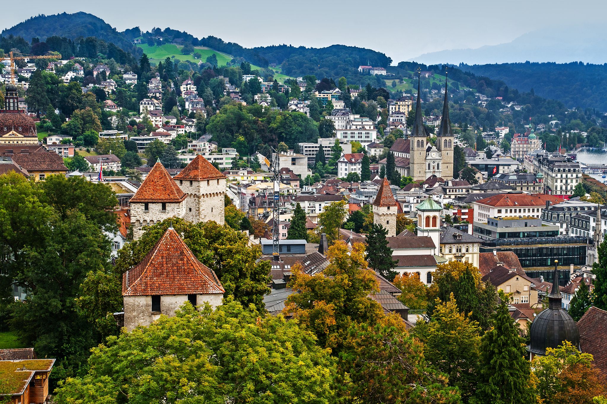 photo of aerial cityscape of Lucerne from City Wall with Church of St Leodegar, Lucerne, Switzerland.