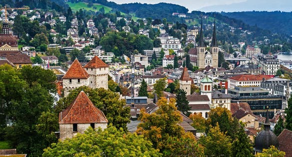 photo of aerial cityscape of Lucerne from City Wall with Church of St Leodegar, Lucerne, Switzerland.