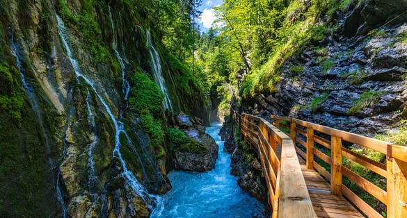 Photo of Beautiful Wimbachklamm gorge with wooden path in autumn colors, Ramsau bei Berchtesgaden in Germany. Waterfall at Wimbachklamm near Ramsau-Berchtesgaden, Bavaria, Germany.